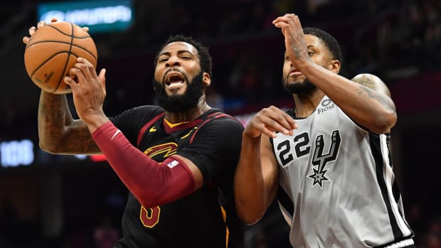 Cleveland Cavaliers center Andre Drummond drives to the basket against San Antonio Spurs forward Rudy Gay during a game at Rocket Mortgage FieldHouse.